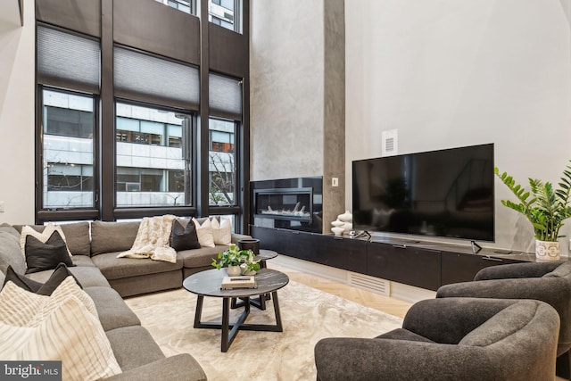 living room featuring a high ceiling and a wealth of natural light