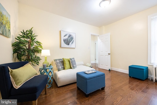 living room with plenty of natural light and dark hardwood / wood-style flooring