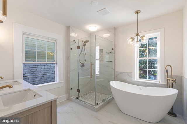 bathroom featuring vanity, separate shower and tub, and a notable chandelier