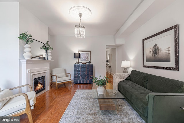 living room featuring hardwood / wood-style flooring and an inviting chandelier