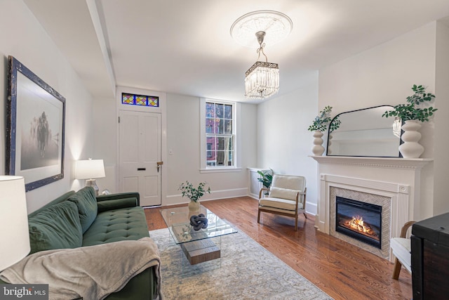 living room featuring wood-type flooring and an inviting chandelier