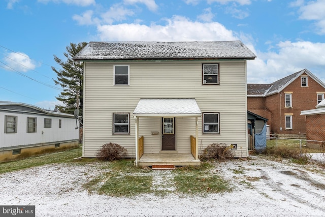 view of snow covered rear of property