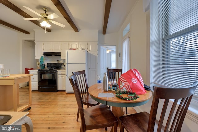 dining space with a wealth of natural light, beamed ceiling, light hardwood / wood-style floors, and ceiling fan