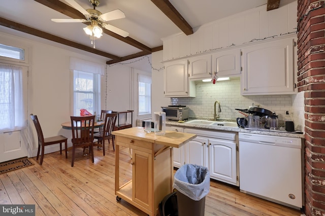 kitchen featuring white dishwasher, sink, beam ceiling, white cabinets, and light hardwood / wood-style floors