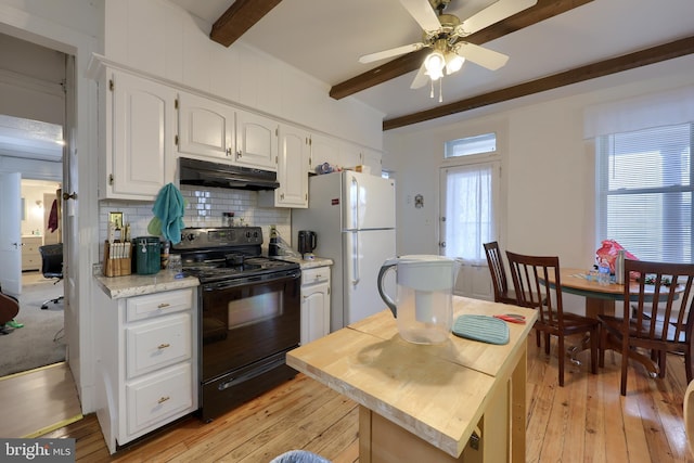 kitchen with white cabinets, white fridge, a healthy amount of sunlight, and black range with electric cooktop