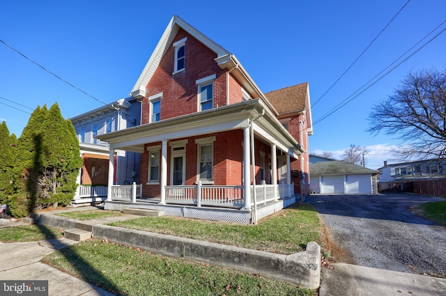 view of front of property featuring an outbuilding, a porch, and a garage