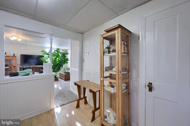 interior space featuring light hardwood / wood-style floors and a drop ceiling