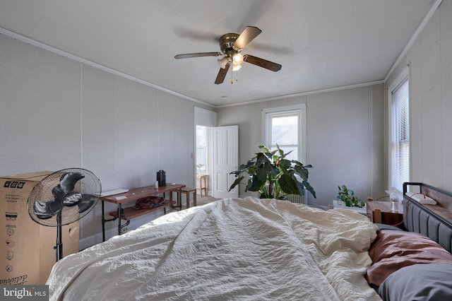 bedroom featuring hardwood / wood-style floors, ceiling fan, and crown molding