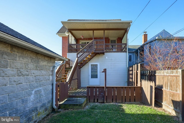 rear view of house with a yard