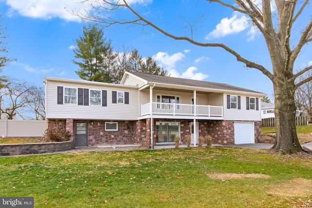 view of front of home with a balcony, a front yard, and a garage