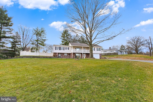 view of front of home with a front yard and a garage