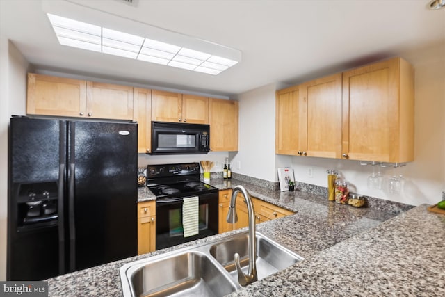 kitchen featuring black appliances, light brown cabinets, and sink