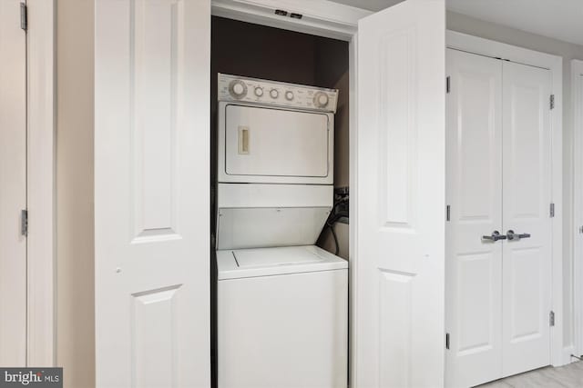 laundry area with stacked washer / dryer