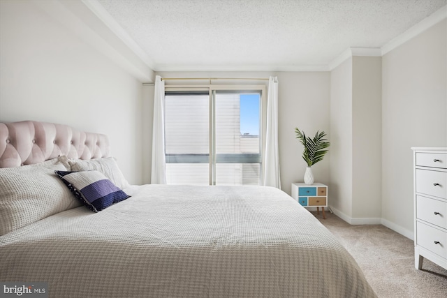 bedroom featuring crown molding, a textured ceiling, and light carpet