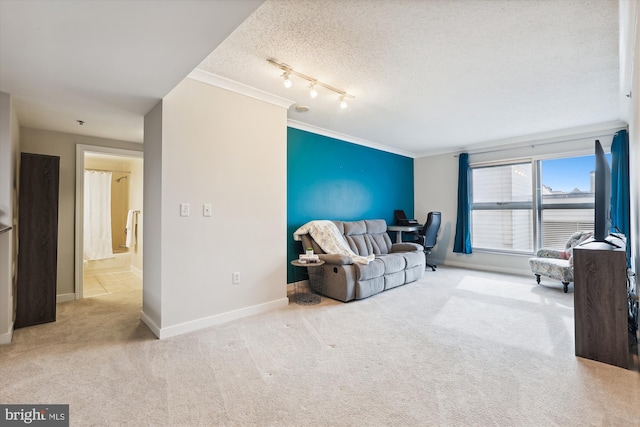 living room with ornamental molding, a textured ceiling, light carpet, and track lighting