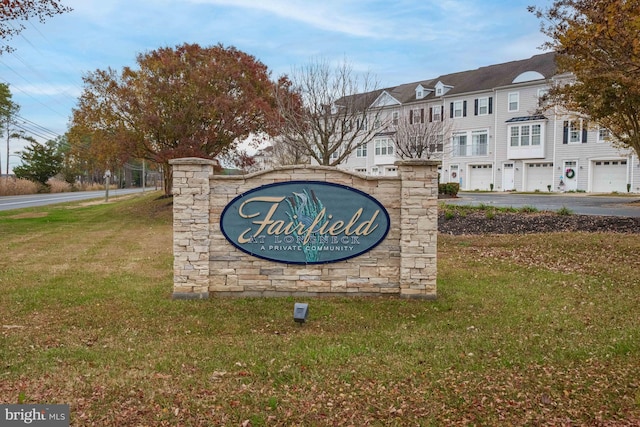 community sign featuring a lawn