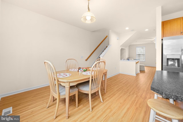 dining space with light hardwood / wood-style flooring