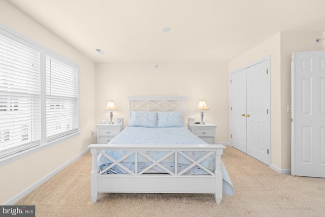 carpeted bedroom with a closet