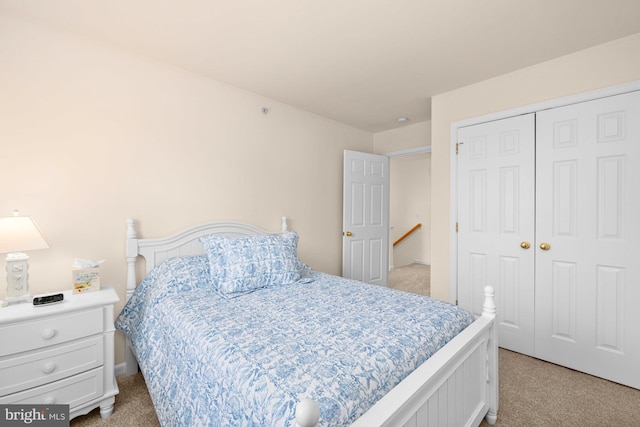 bedroom with light colored carpet and a closet