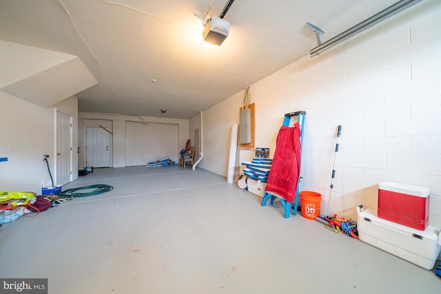 garage with electric panel and a garage door opener