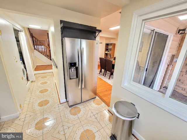 kitchen featuring stainless steel fridge and light hardwood / wood-style floors