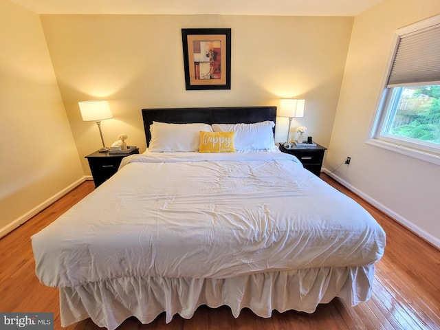 bedroom with hardwood / wood-style floors