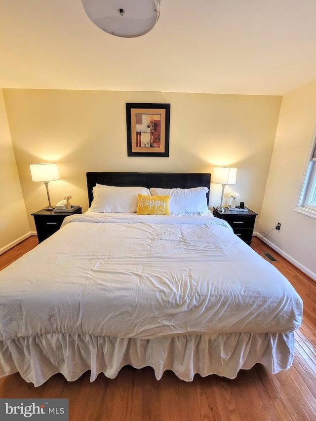 bedroom with hardwood / wood-style flooring