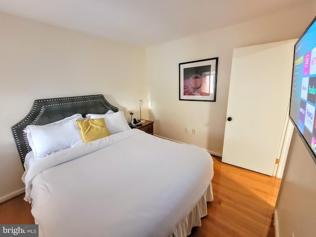 bedroom with hardwood / wood-style flooring