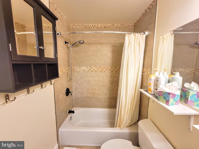 bathroom featuring toilet and shower / bath combo with shower curtain