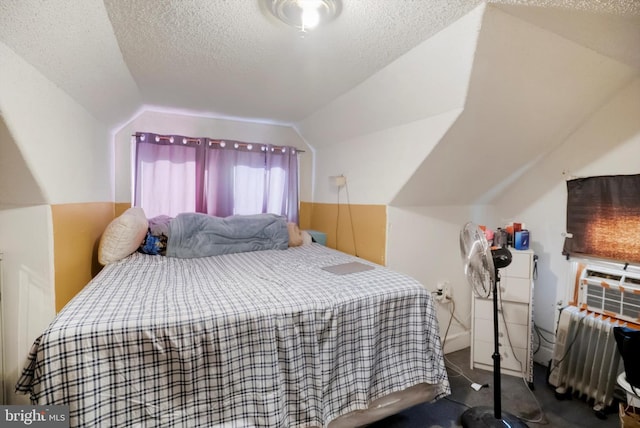 bedroom with a textured ceiling, carpet floors, and lofted ceiling