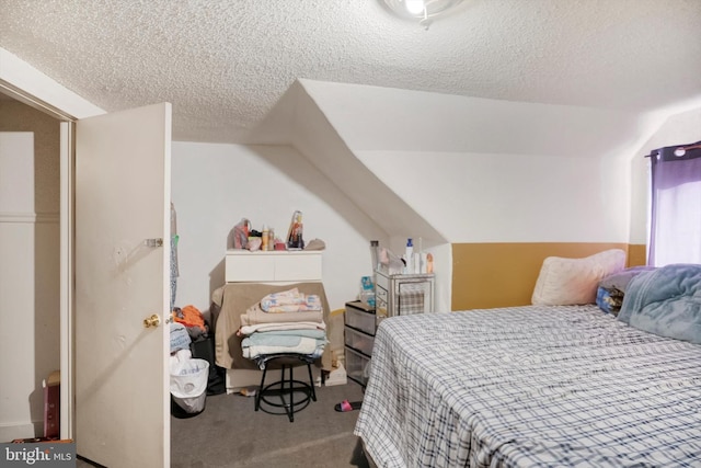 bedroom with carpet floors, a textured ceiling, and vaulted ceiling