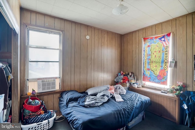 bedroom with carpet, cooling unit, and wood walls