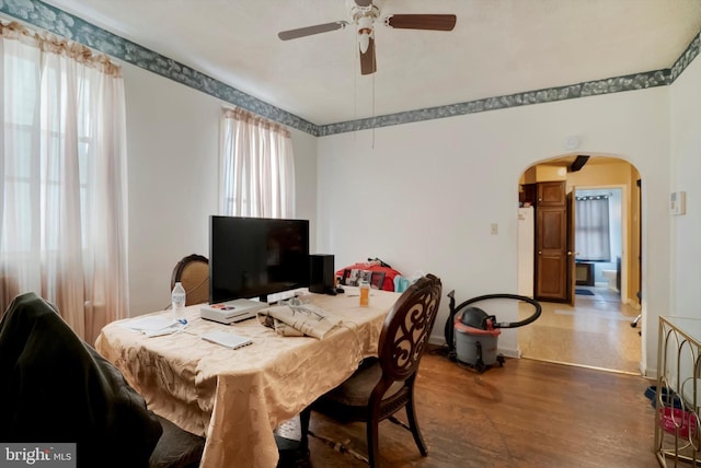 dining area featuring ceiling fan and dark hardwood / wood-style floors