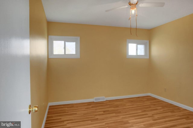 spare room featuring light hardwood / wood-style flooring and ceiling fan