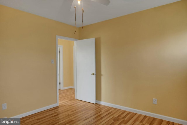 spare room featuring ceiling fan and light wood-type flooring