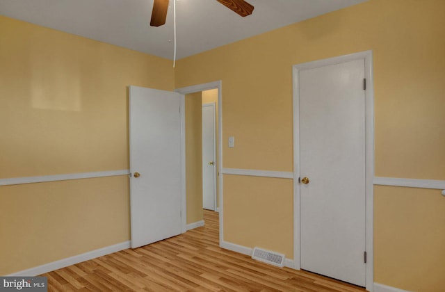 unfurnished bedroom with light hardwood / wood-style floors and ceiling fan