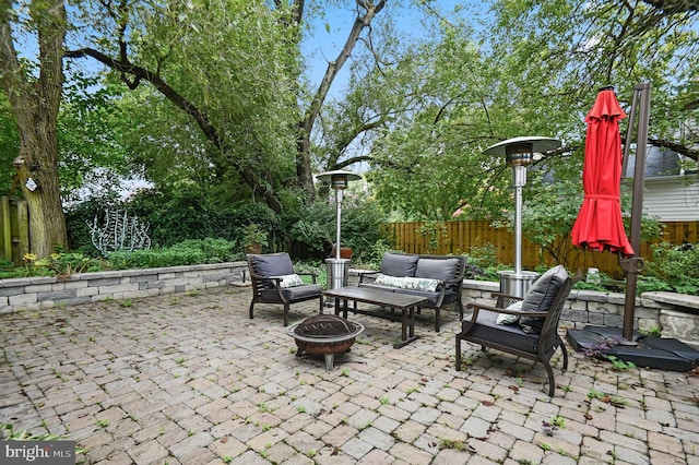 view of patio / terrace featuring an outdoor living space with a fire pit