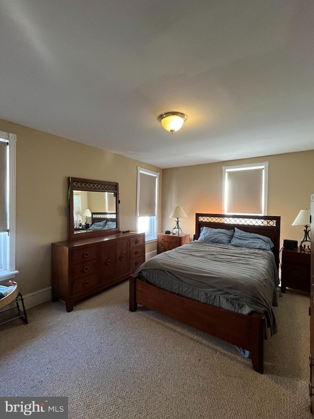 bedroom with light colored carpet