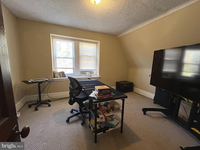 carpeted home office with a textured ceiling