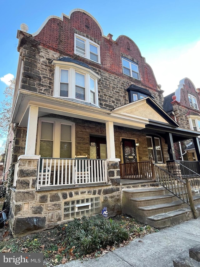 townhome / multi-family property featuring a porch