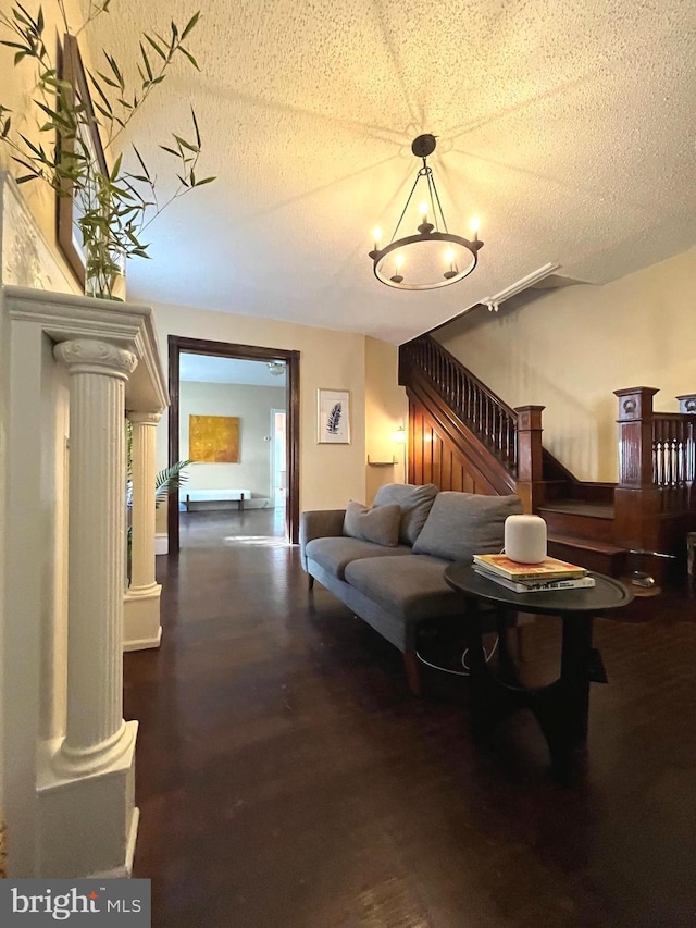 living room featuring dark hardwood / wood-style floors and a textured ceiling