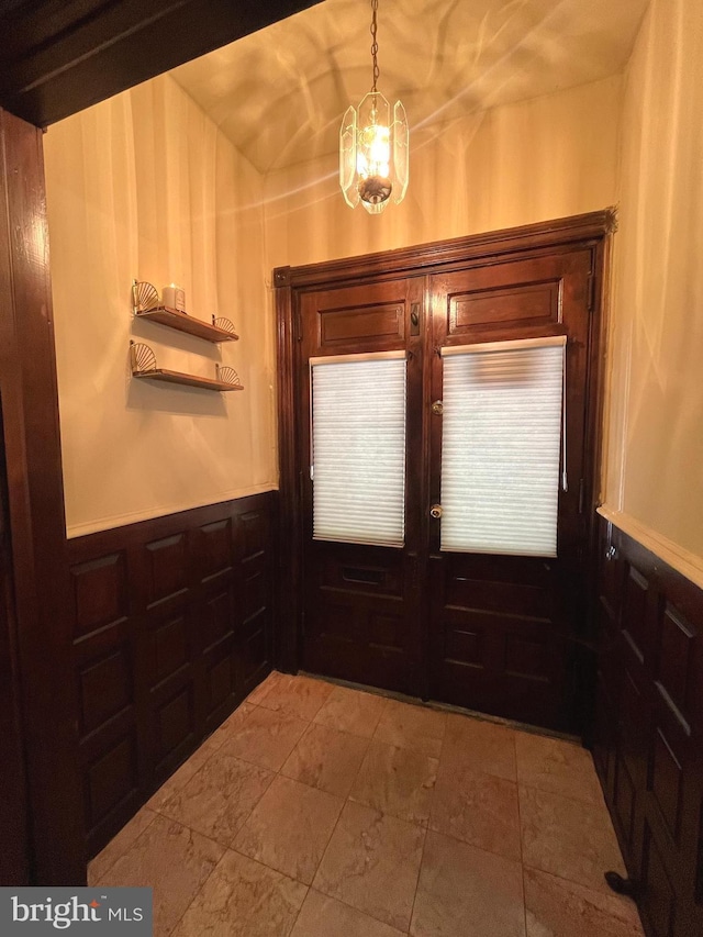 doorway to outside with french doors and a notable chandelier