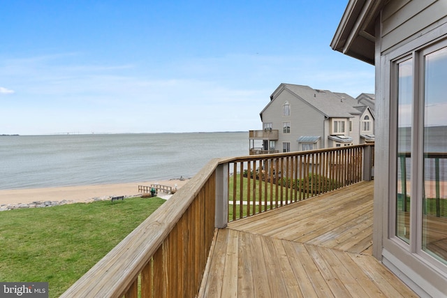 wooden terrace with a water view and a beach view