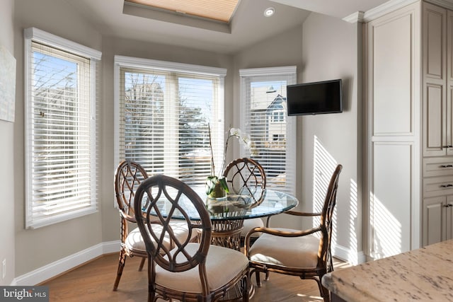 dining space featuring lofted ceiling and light wood-type flooring