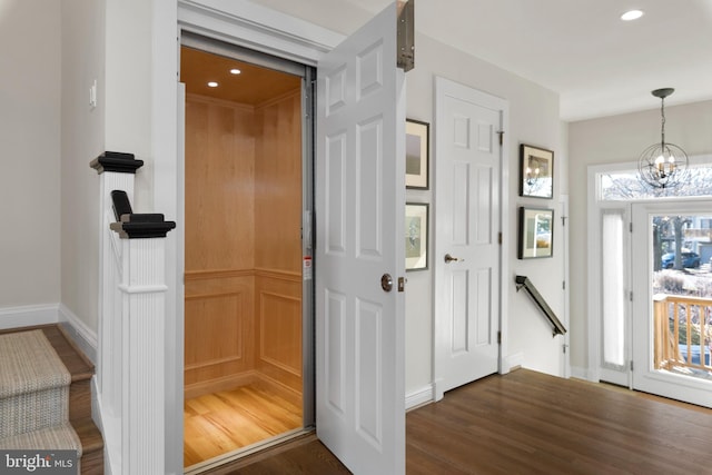 interior space with a chandelier and dark hardwood / wood-style floors