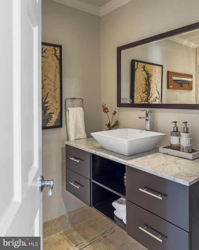 bathroom with crown molding and vanity