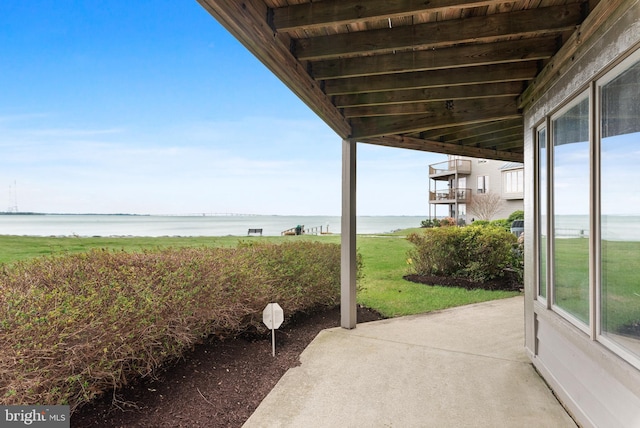 view of patio with a water view