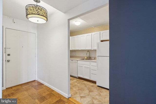 1301 Delaware Ave SW Unit N523, Washington, DC 20024 - kitchen featuring white appliances, a sink, white cabinets, and light countertops
