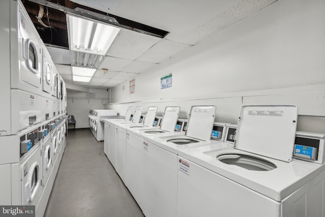 clothes washing area featuring separate washer and dryer and stacked washer / drying machine