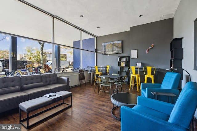 living room with dark wood-type flooring and a textured ceiling